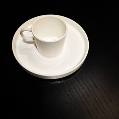 White cup on a black wooden table
