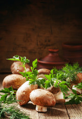 Brown mushrooms on a vintage wooden table, selective focus