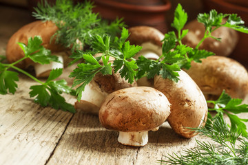 Brown mushrooms on a vintage wooden table, selective focus
