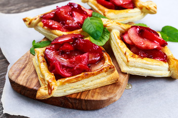 Puff pastry pies with plums, apples, mint and honey