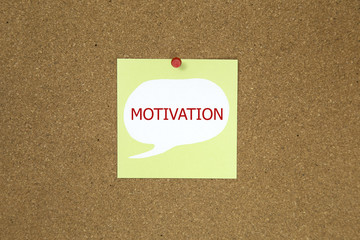 motivation in text on sticky note posted to a cork notice board.