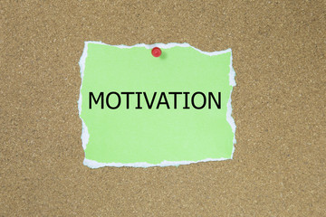 motivation in text on sticky note posted to a cork notice board.
