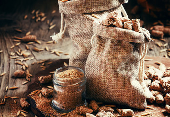 Healthy oat bran in canvas bags, vintage wooden background, sele