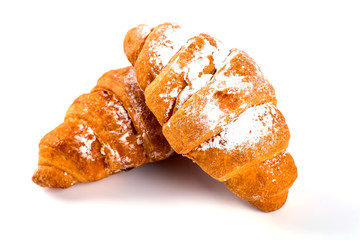 pile of fresh and delicious kroissants and rolls on a white back