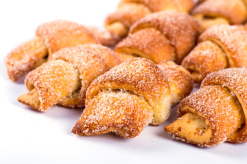 pile of fresh and delicious kroissants and rolls on a white back