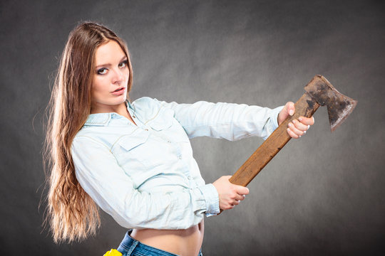 Sexy strong woman feminist with axe working.