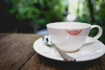 Red lip mark on a tea cup