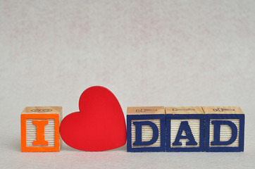 I love dad spelled with colorful alphabet blocks and a red heart isolated on white background - Fathers Day - Powered by Adobe