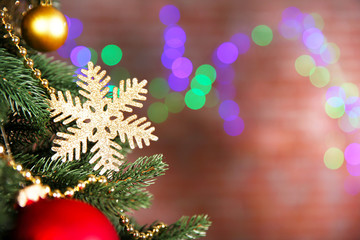 Christmas tree with decor on bright background, closeup