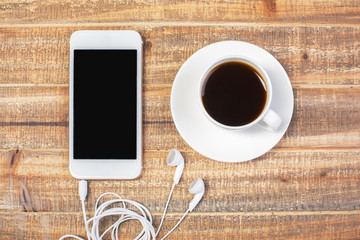 Coffee and cellphone with headphones