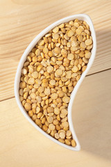 top view of yellow lentils in container.