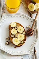 Toast with bananas, peanut butter, nuts and honey