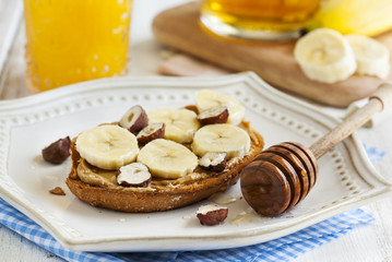 Toast with bananas, peanut butter, nuts and honey