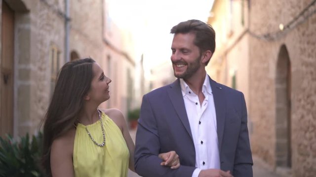 4k footage, beautiful young couple in love walking through old town, woman adoring man
