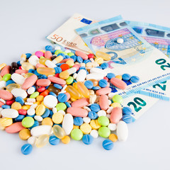 pills on money.  medicine tablets on money