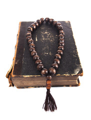rosary beads on old books