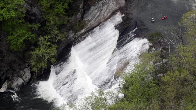 A kayaker slides paddles down Oceania falls in the Tallulah Gorge