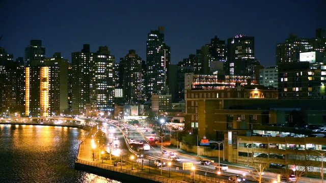 East Harlem neighborhood skyline with rush hour traffic on FDR drive, at night, in Manhattan, New York City