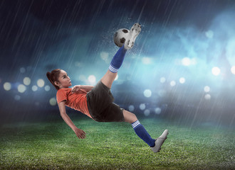 Asian woman football player kick ball