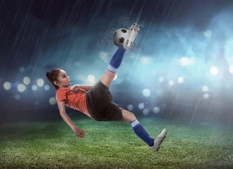 Foto auf Acrylglas Asian woman football player kick ball © Leo Lintang