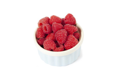 raspberries on white bowl