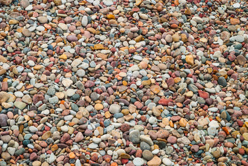 Background of pebble stones on beach, texture