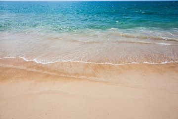 Fototapeta na wymiar Sea wave blue color on the tropical beach