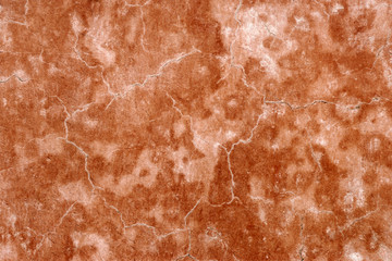 Old cracked grunge orange or brown plaster concrete wall surface texture background photo