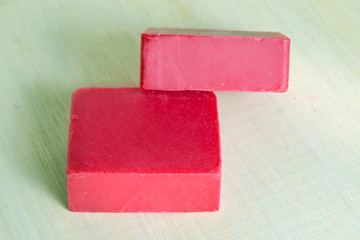 Soap bar flavor with strawberry ingredient isolated on wooden bo