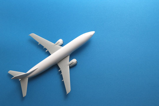 Toy airplane on blue background.
