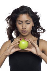 beautiful young woman holding a green apple
