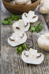 Fototapeta na wymiar Raw mushrooms on a wooden table