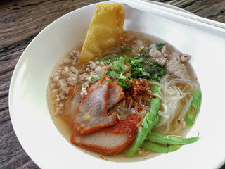 Thai style tom yum noodle on wooden table