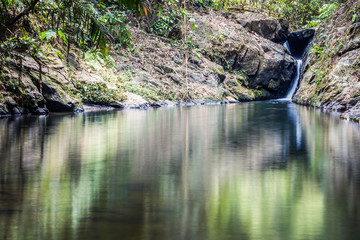 Stoned waterfall. A narrow water flow between the stones in the forest,Raman waterfall - Phang Nga Province ,Thailand