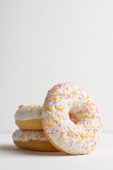 Donut with sprinkles on the white background