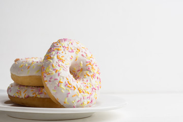 Donut with sprinkles on the white background