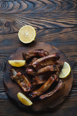 Above view of sliced baked pork ribs with lemon, studio shot