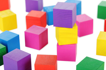 Colorful wooden toy cubes on a white background