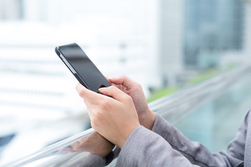 Businesswoman sending text message on mobile phone