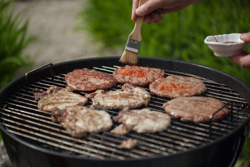 Putting sauce on burgers