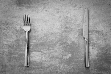 Fork and knife on concrete background