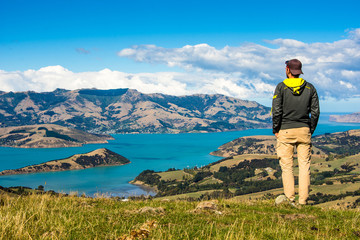 Men watching the Bay of Akaroa, New Zealand 