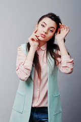 Close up face portrait of young brunette girl wearing in pink bl