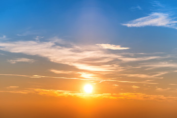 Naklejka na ściany i meble Sunset in the sky with blue orange clouds