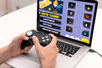 Young man playing computer games at home © Africa Studio