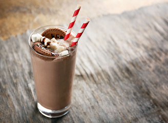 Delicious milk cocktail on rustic background, close up