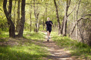 Obraz premium Senior Man Running in the Forest