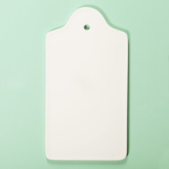 White ceramic serving board over light blue background