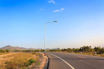 road on country side with clouds and blue sky