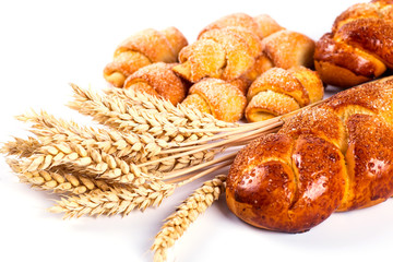 pile of fresh and delicious kroissants and rolls on a white back